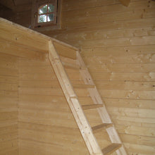 Load image into Gallery viewer, Interior of the Emily 400 cabin featuring wooden walls, stairs leading to a loft, and natural lighting through windows.