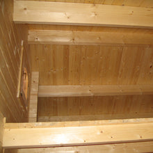 Load image into Gallery viewer, Loft area of the Emily 400 cabin with a small wooden window by WholeWoodCabins
