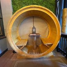 Load image into Gallery viewer, Wooden hamster wheel with benches and a small table inside, resembling a cozy nook.
